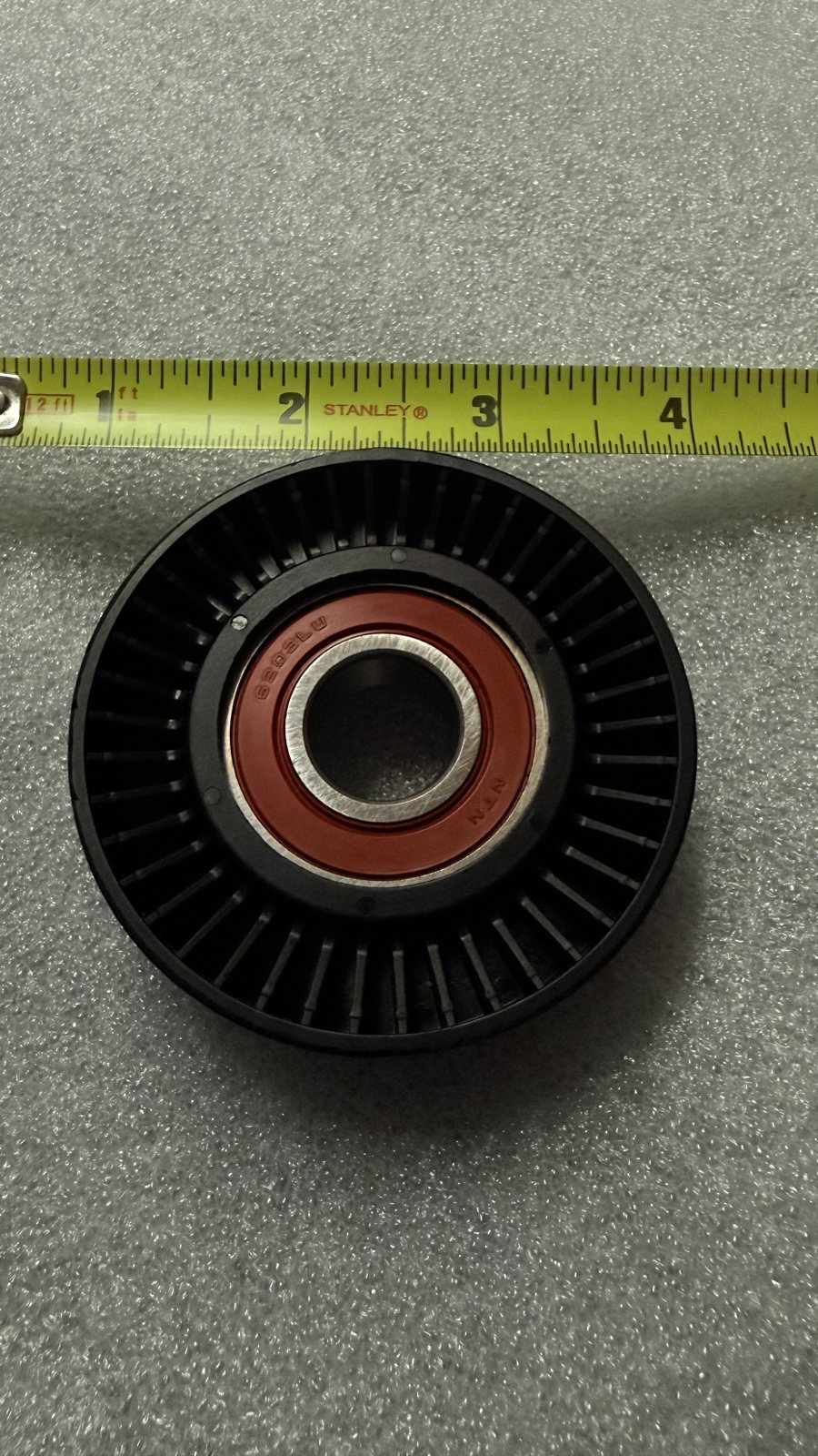 Serpentine belt idler pulley, black plastic with NTN bearing